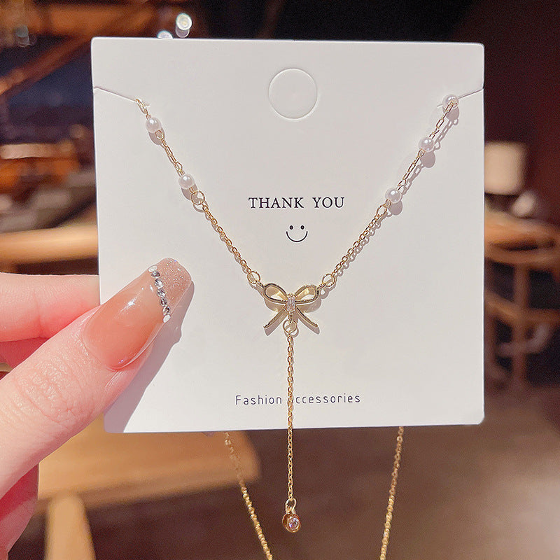 Bow and Tassel Pendant Necklace with Geometric Design in Gold Tone
