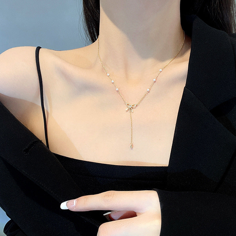 Bow and Tassel Pendant Necklace with Geometric Design in Gold Tone