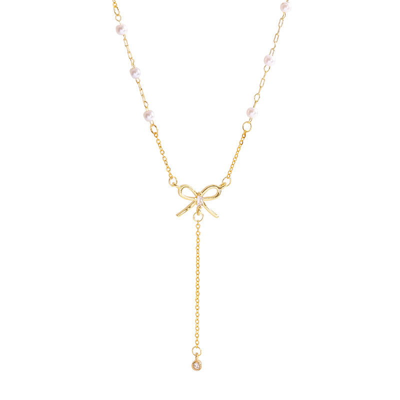 Bow and Tassel Pendant Necklace with Geometric Design in Gold Tone
